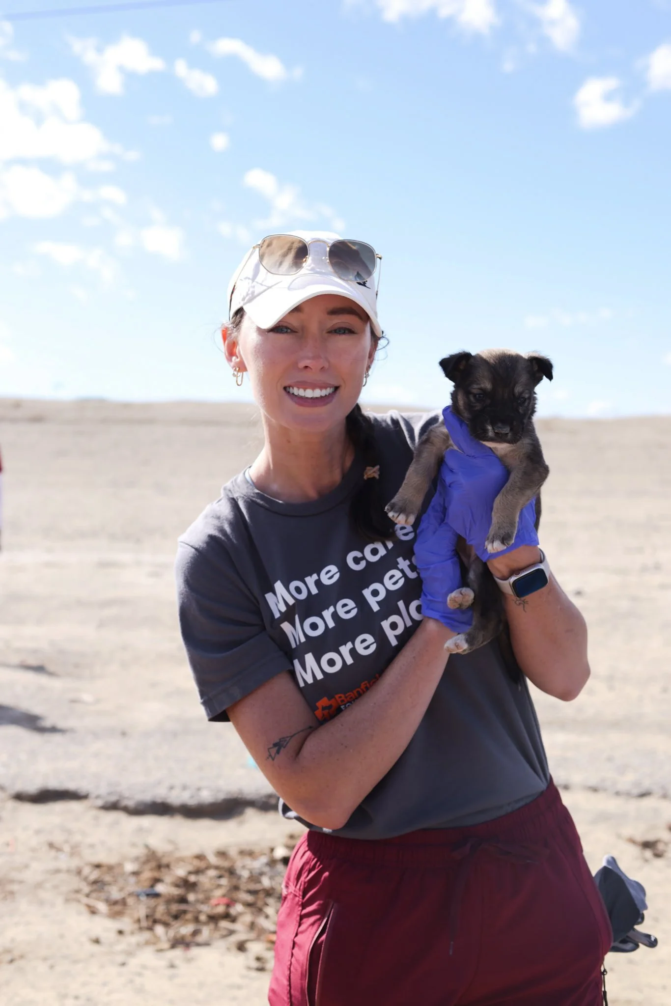 Volunteering in New Mexico within the Navajo Nation Community. Holding a puppy and gloves. Building Enclosures to keep pets safe from wildlife, cars, and other dangers. 