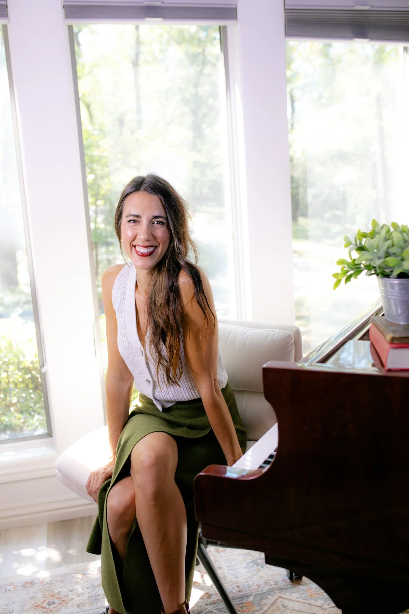 Professional Vocal Coach Monica Sadler next to Grand Piano