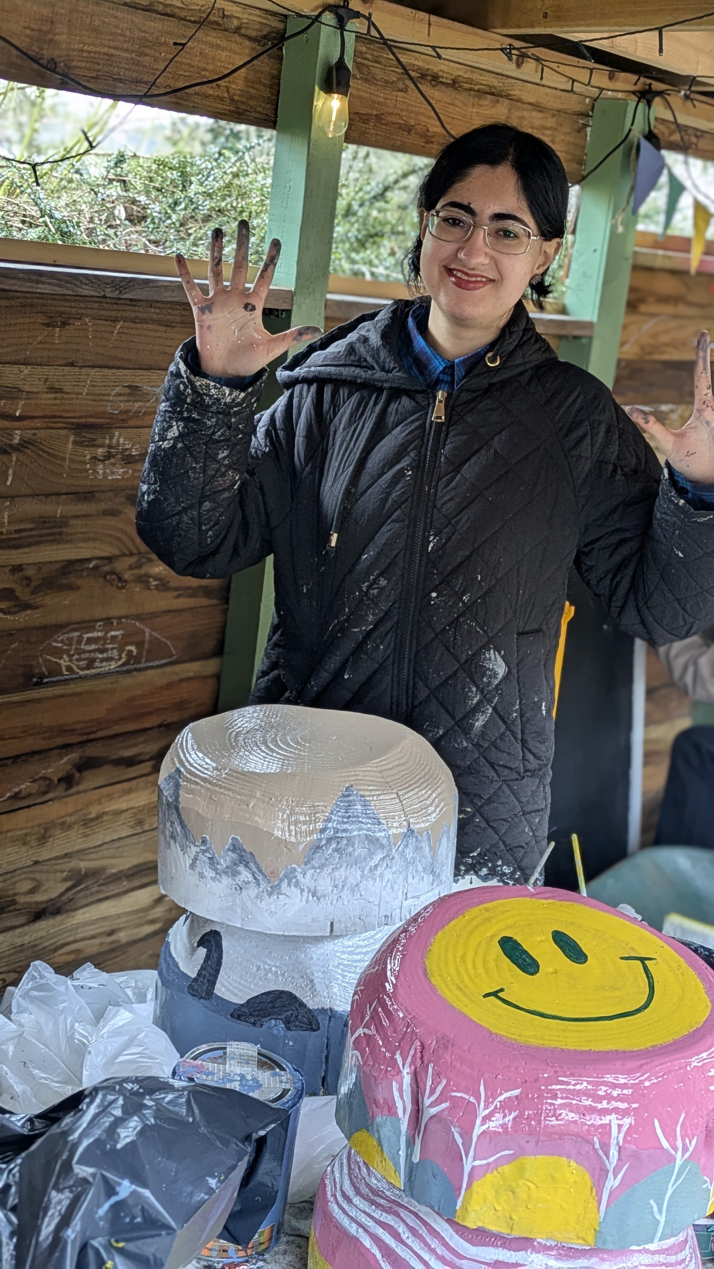 Aysha shows off her painty hands and mountain mushroom complete with Loch ness monster