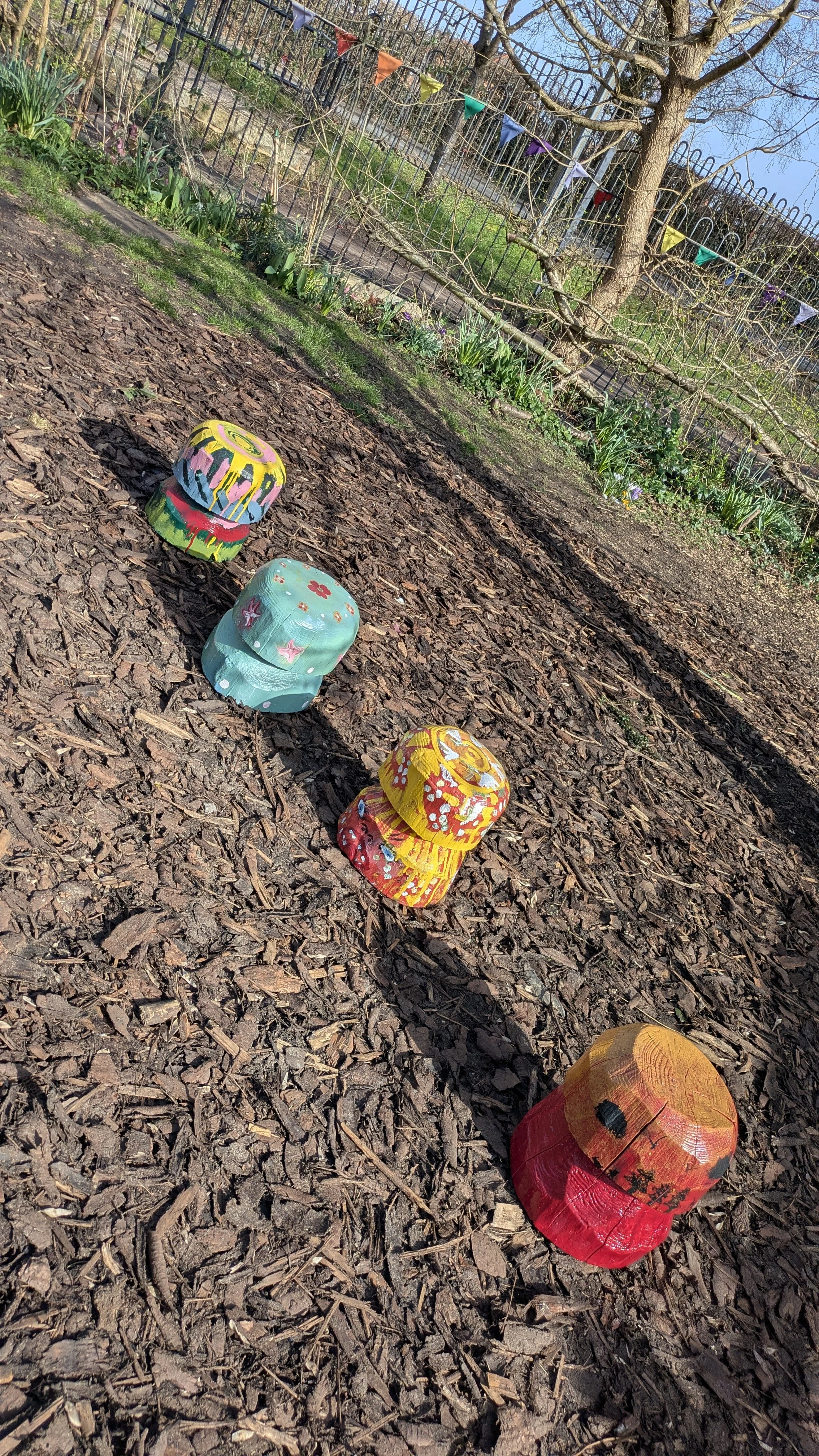The mushrooms pose outside in the playpark at Flo's - a place in the park,  where they now live