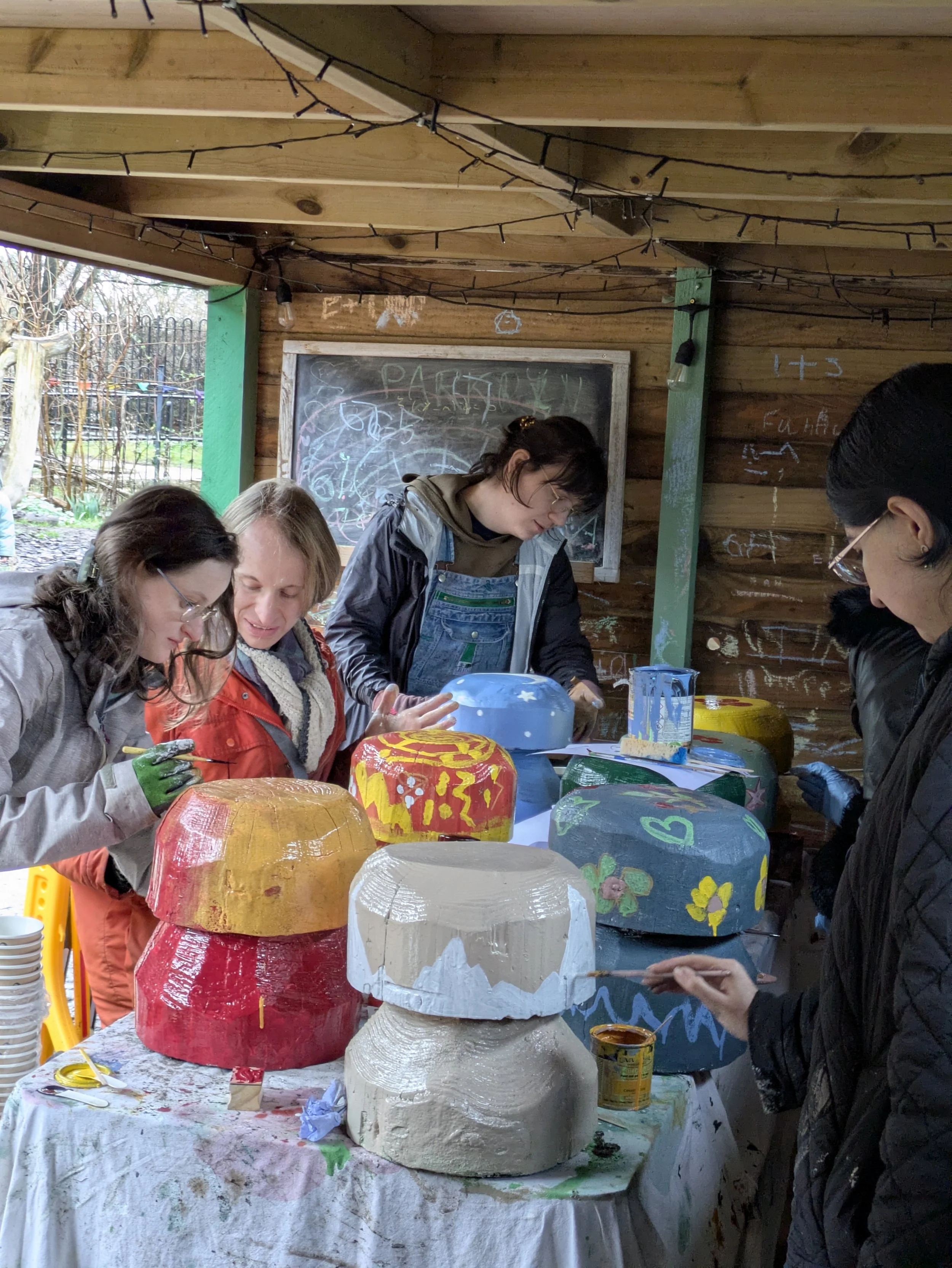 The gardening group busy painting their mushrooms. From left to right Lucy, Tom, Angelica and Aysha 