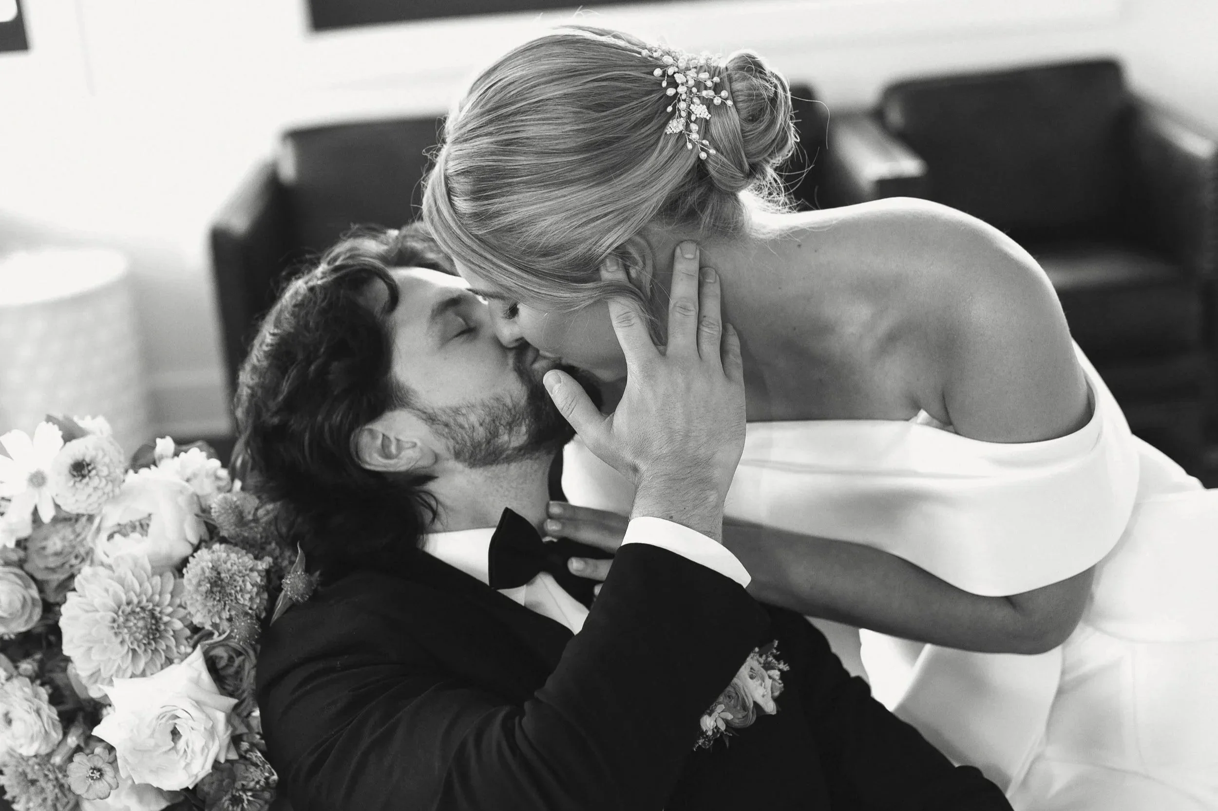 Romantic, editorial photo of Kansas bride and groom kissing dressed in wedding dress and tuxedo.
