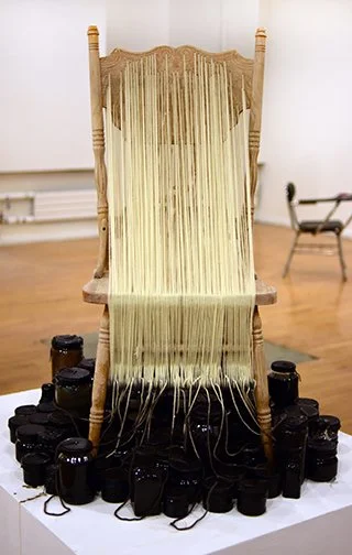 Processing, 2019, Yarn, wood, jars, wax, dye, and chair  42 x 19 x 20 inches