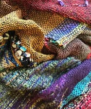 Close-up of colorful, woven textile fabrics layered together.