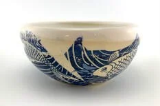A ceramic bowl with a blue and white floral pattern.