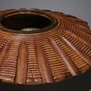 Close-up of a traditional woven basket with a circular opening at the top.