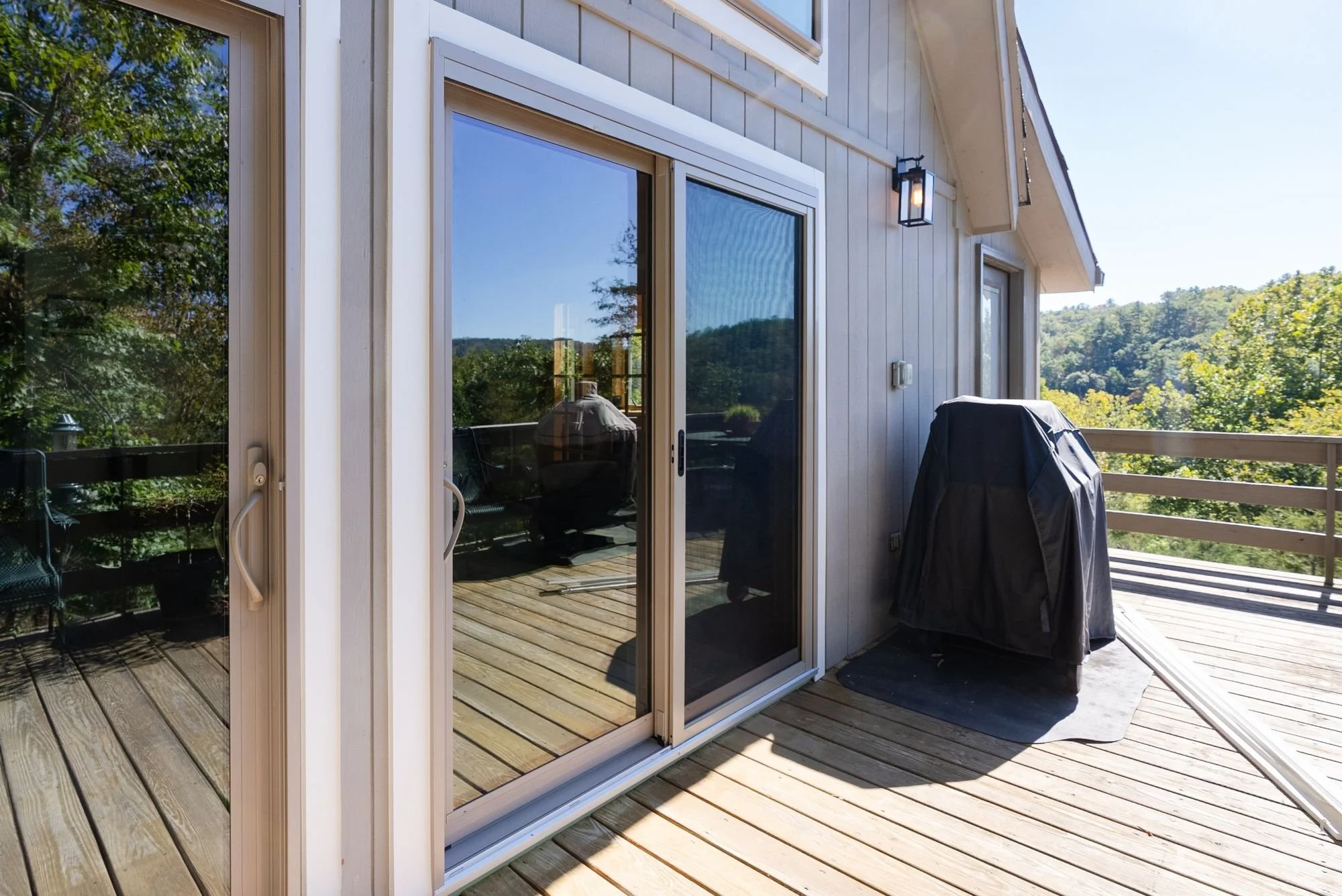 Exterior of a ProVia Endure sliding patio door with low-E glass and a neutral frame on a deck in Rockingham County, VA