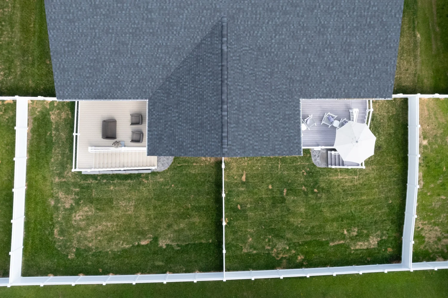 Straight-down view of the two porch roofs and the fenced backyards below