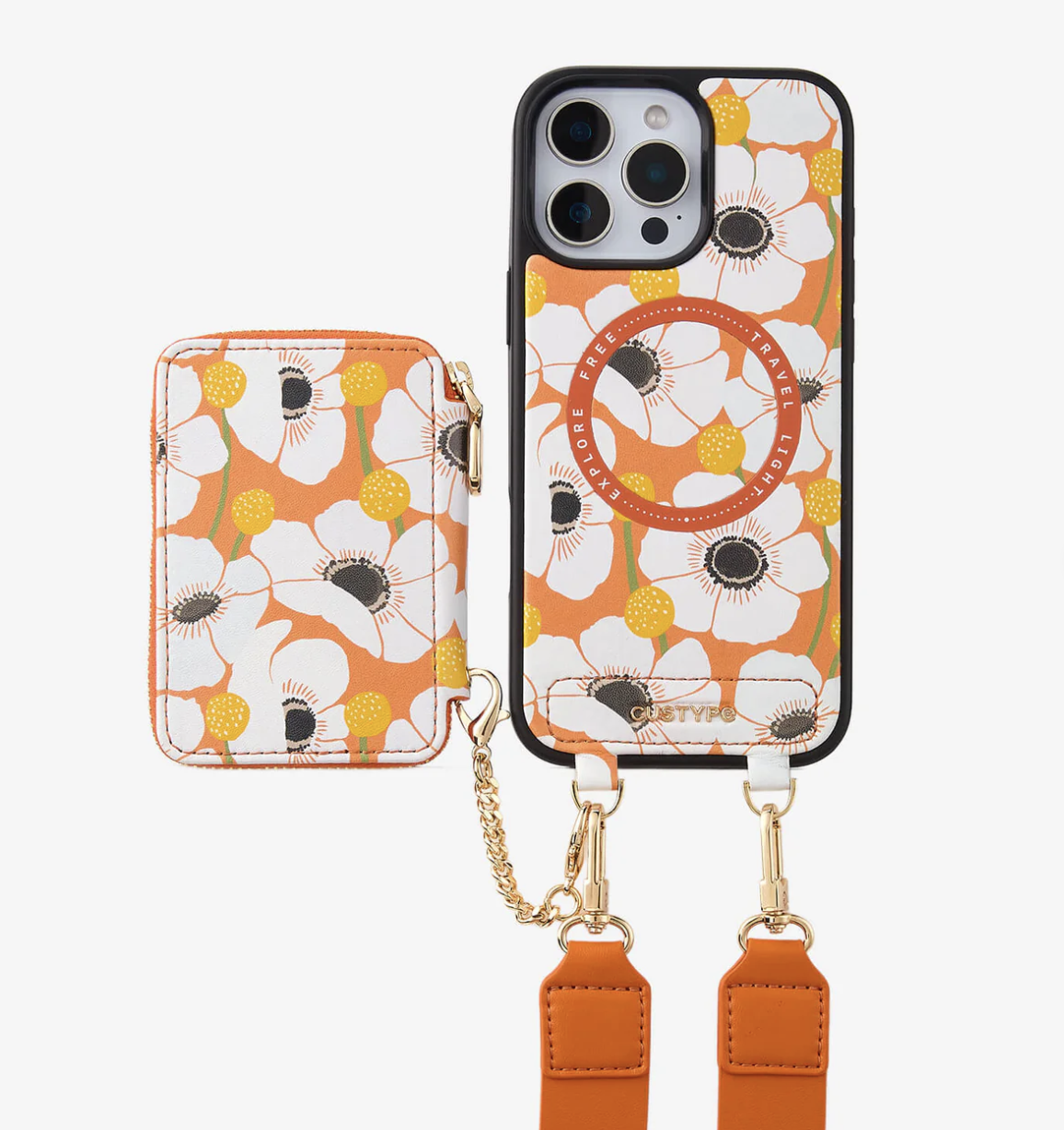 Matching phone case and card holder with orange and white floral design, attached with straps and gold hardware.