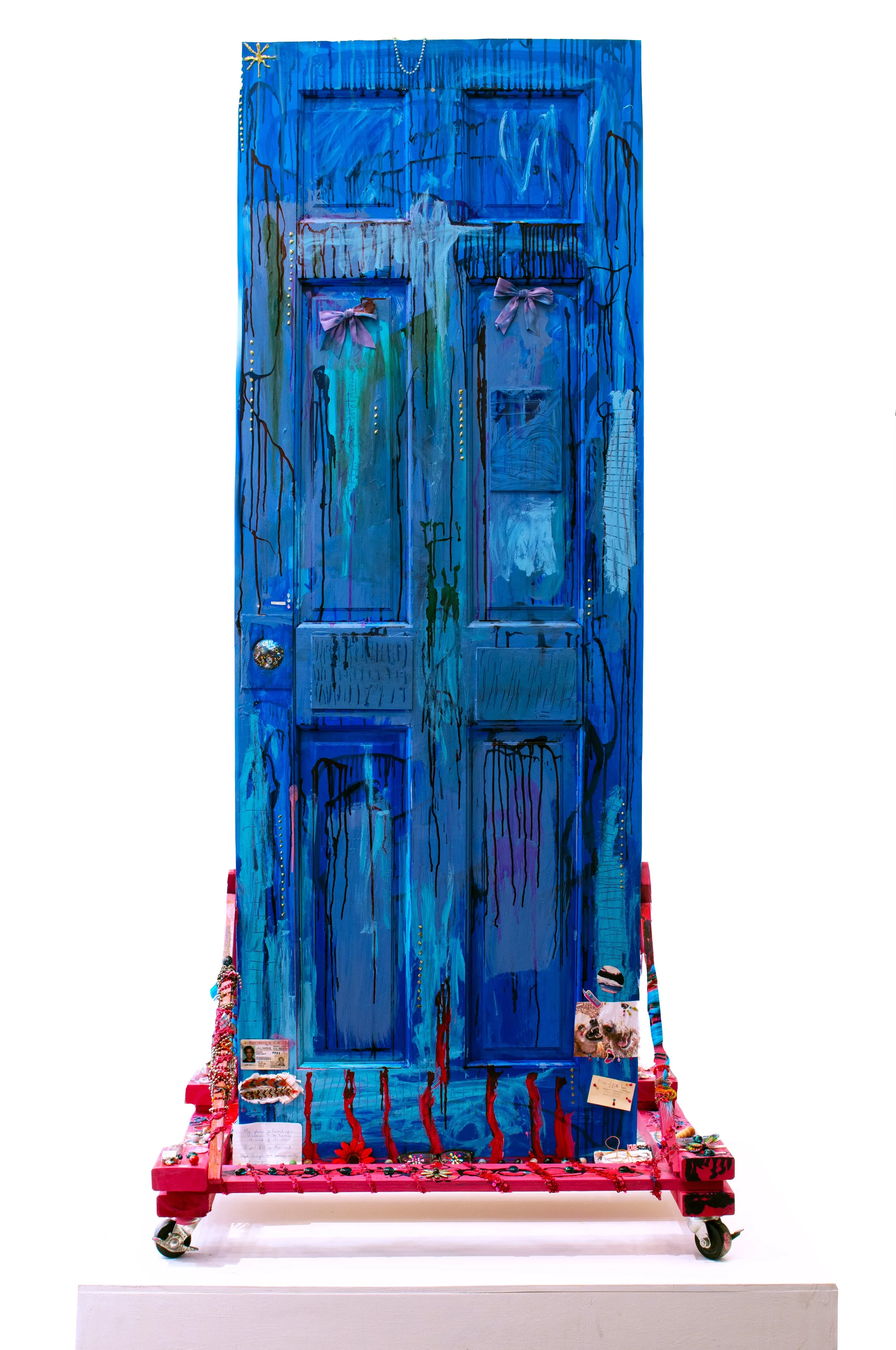Altar, The Door | One Side | 2025 | Acrylic, found door, ink, wood, nails, wheels, fabric, E6000 superglue, glitter, jewelry, beads, resin, personal collections of things, glass, etc. | 82 x 42 x 33 inches | 208 x 106.68 x 83.82 cm 