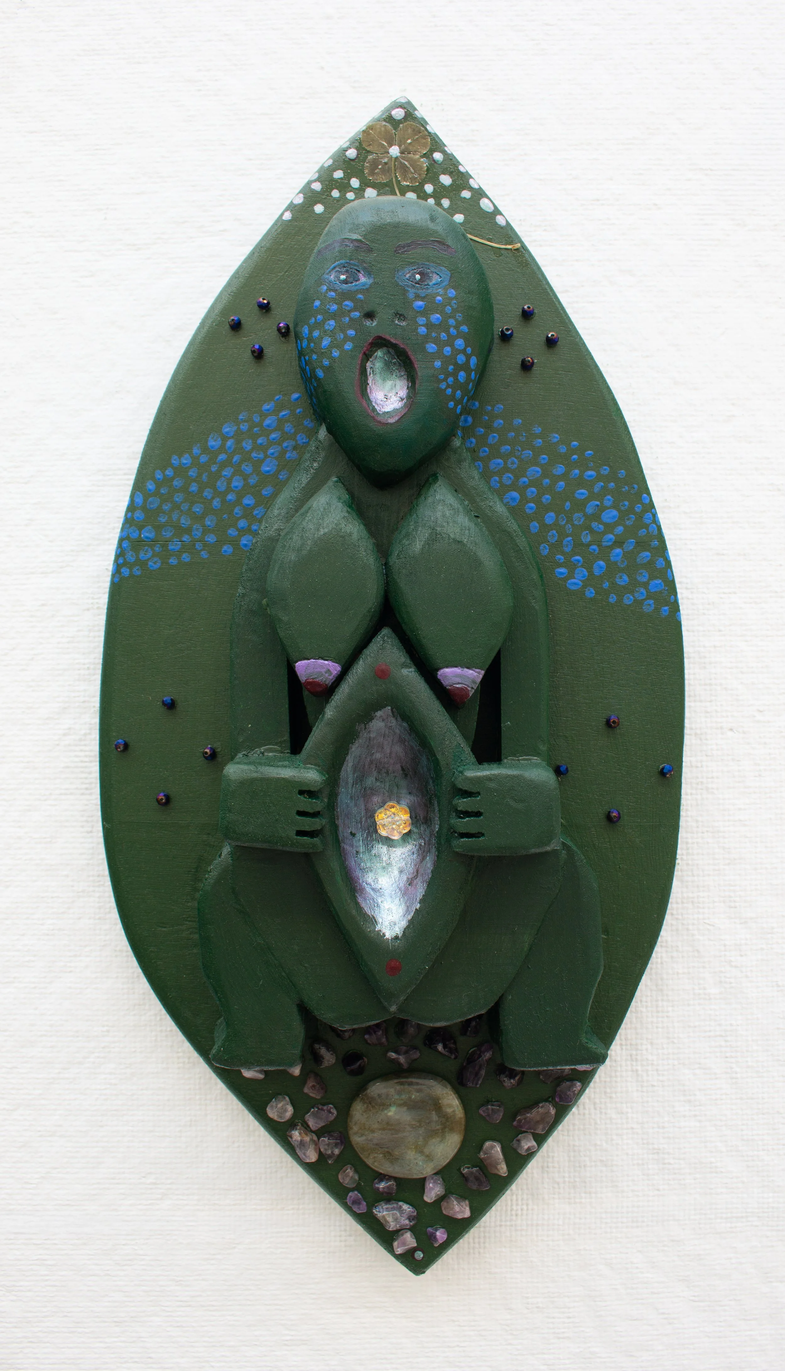 Sheela na gig | 2026 | Wood, acrylic paint, nail polish, various beads and stones, four-leaf clover, superglue | 16 x 7.5 x  3 in | 40.64 x 19.05 x 7.62 cm 