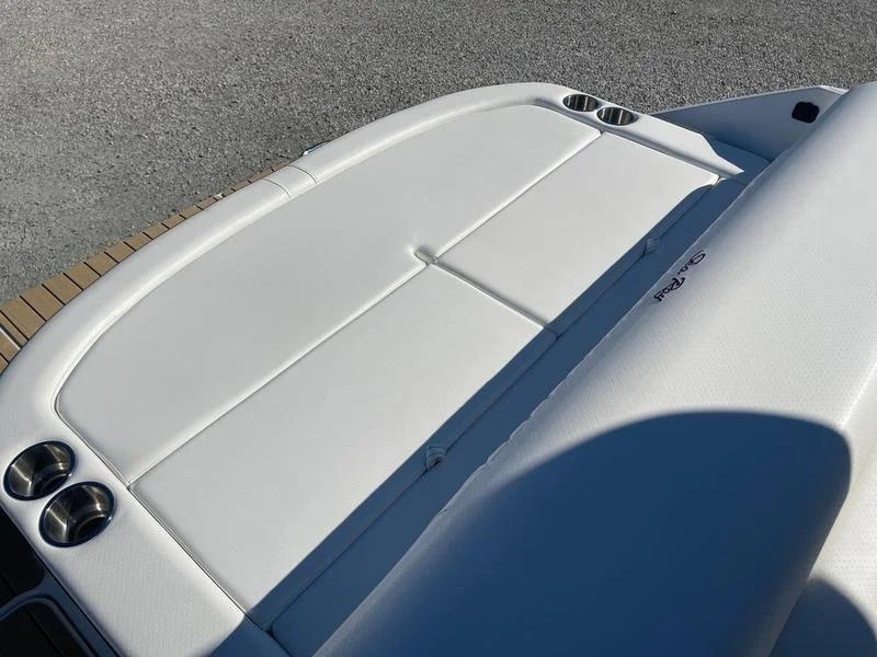 Close-up view of a white boat swim platform with cup holders, parked on a boat trailer. Sea Ray 280 SLX.