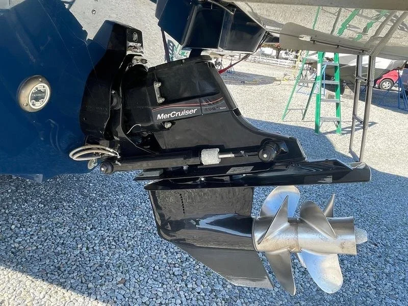 A boat's outboard motor with a Mercury MerCruiser branding, attached to the stern of the boat, with a metal propeller. Sea Ray 280 SLX.