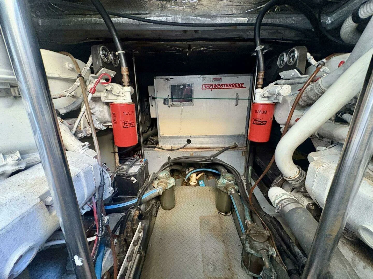 Yacht engine room, showing engine components, filters, and electrical equipment. Cummins diesel engines. Sea Ray luxury yacht.