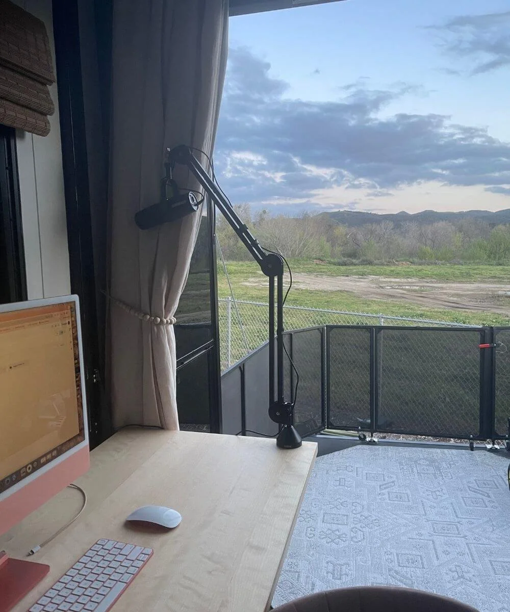 a podcast microphone with a view of the mountains behinds it