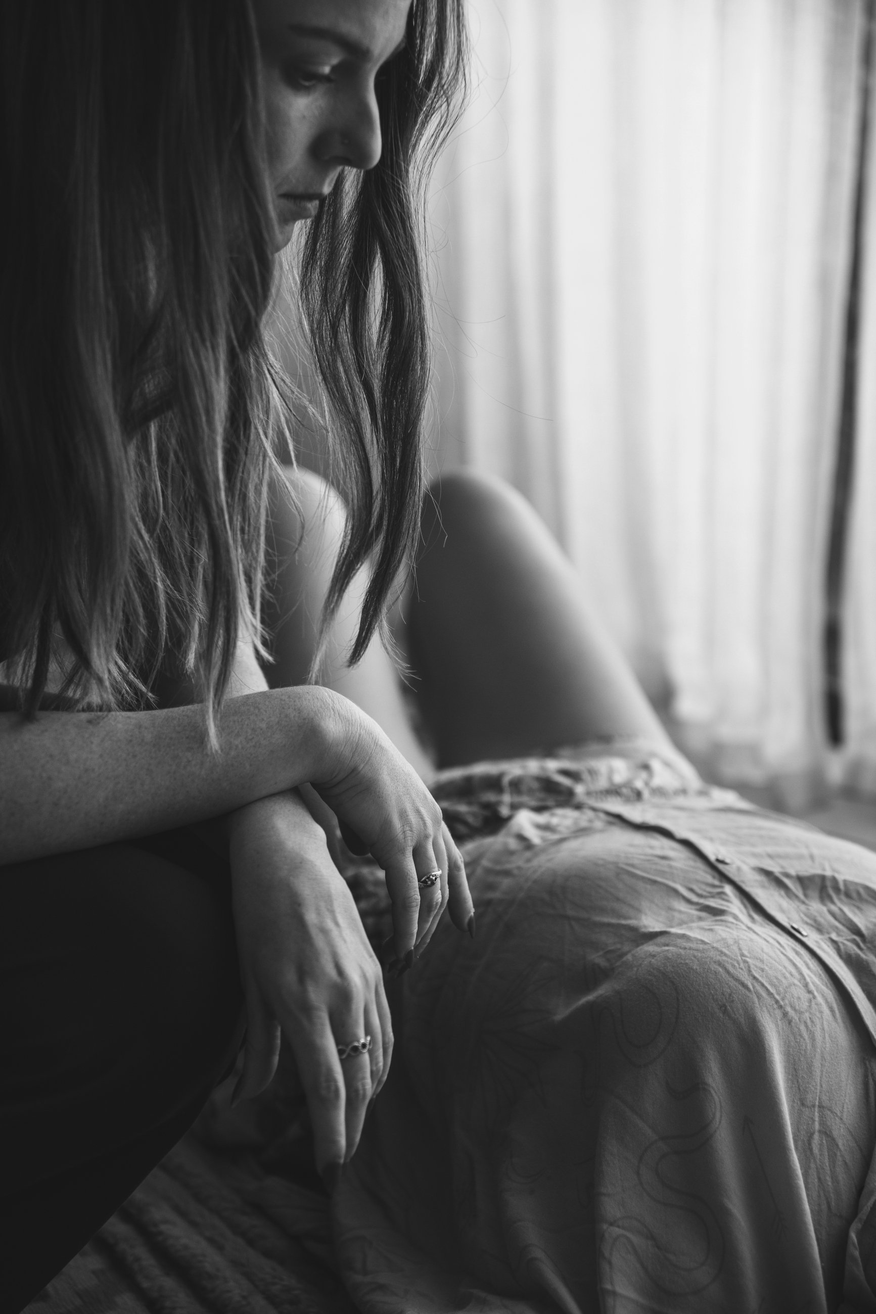 A black and white photo of a woman holding space for another women