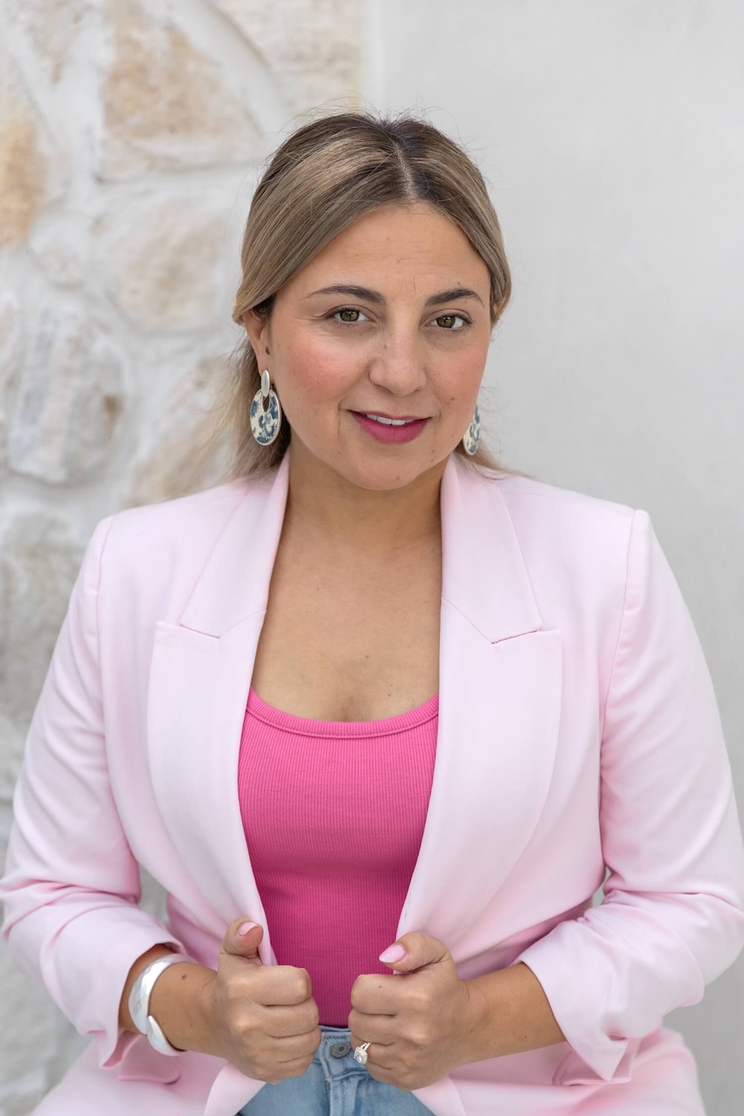 Women in all pink outfit outside headshot