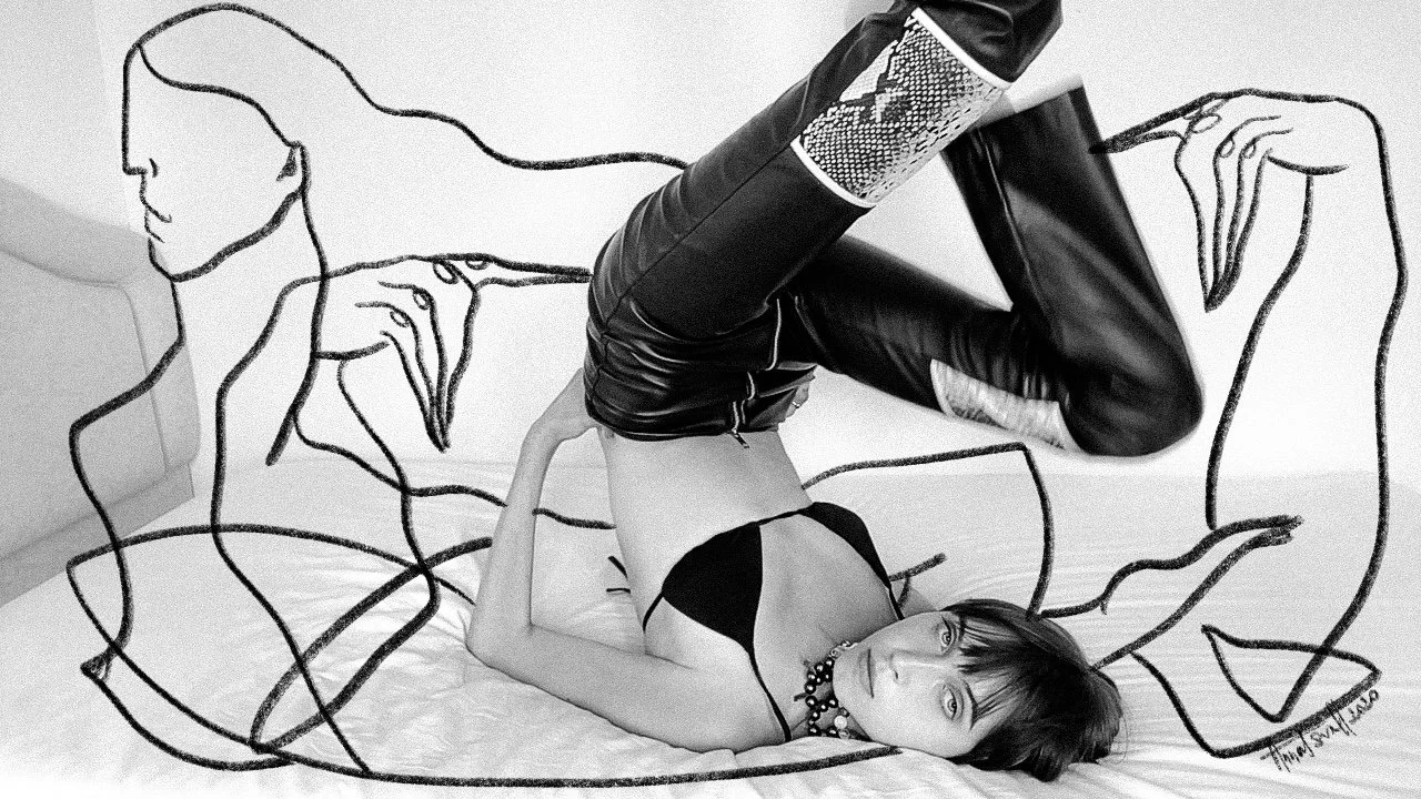 A black and white photo of a person in leather pants and a black top, posed on a bed. The image features artistic line drawings surrounding the subject, depicting abstract human figures and hands.