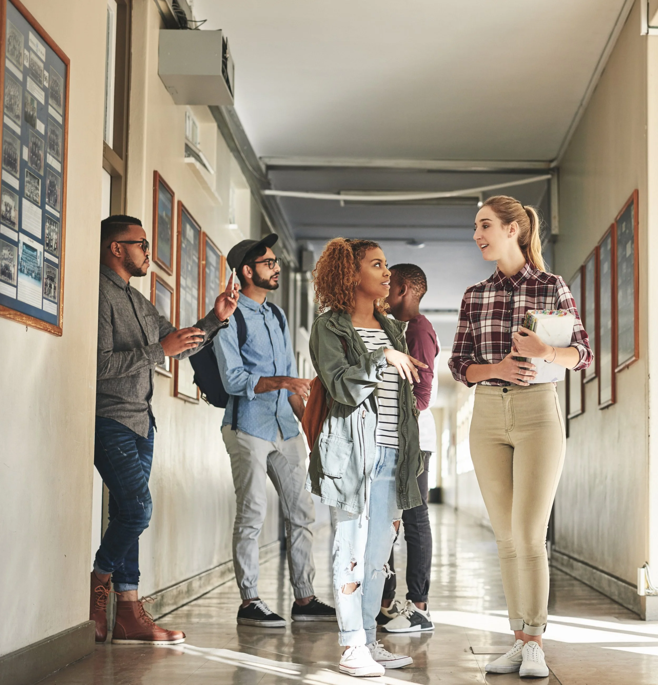 Grupo de estudiantes conversando en un pasillo del colegio.
