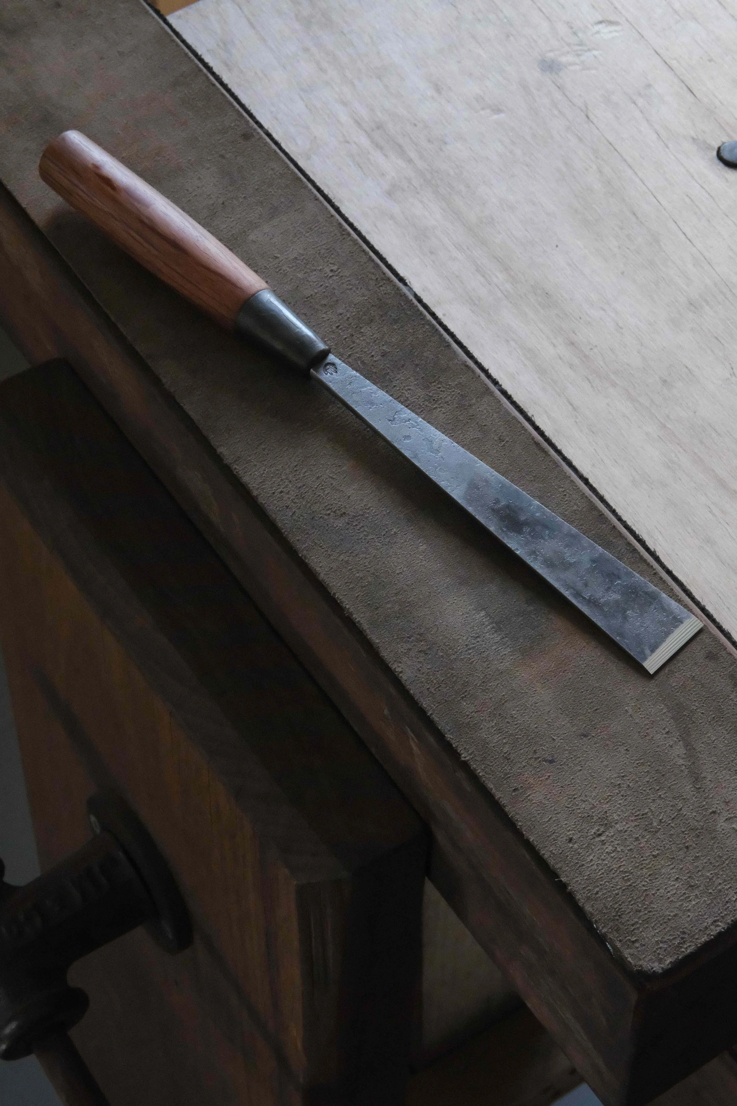 Straight chisel sitting on bench