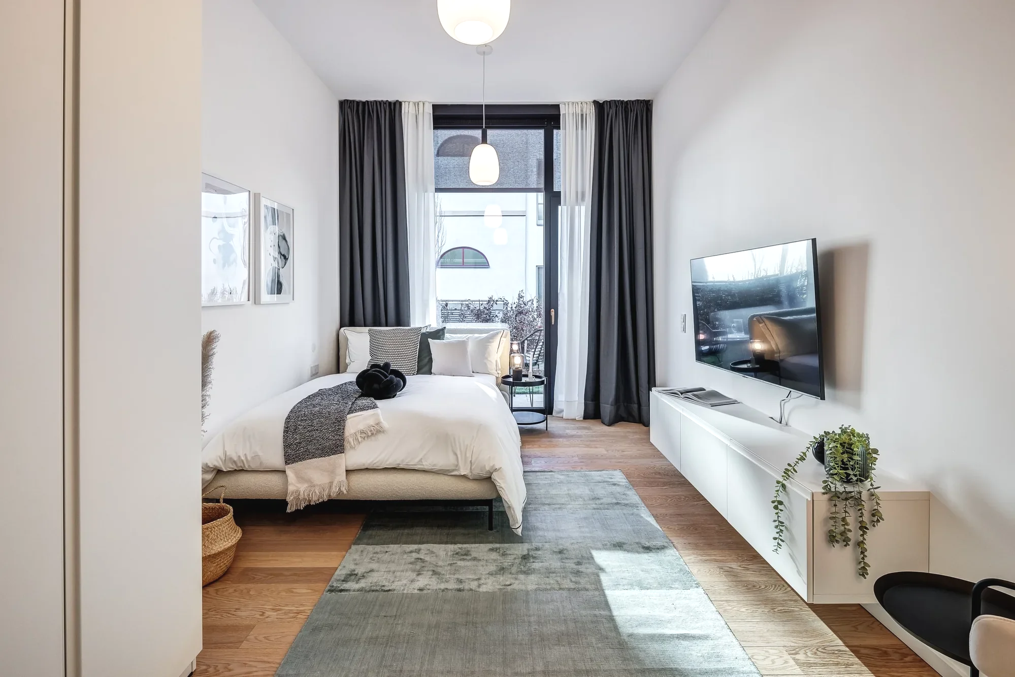 Modernes Schlafzimmer mit Doppelbett, Holzboden, natürliche Beleuchtung. modernes Zimmer als 1-Zimmer Wohnung gestalten mit Onterior. Apartment einrichten mit Onterior. Einirichtungsplanung und Beratung Online, deutschlandweit.