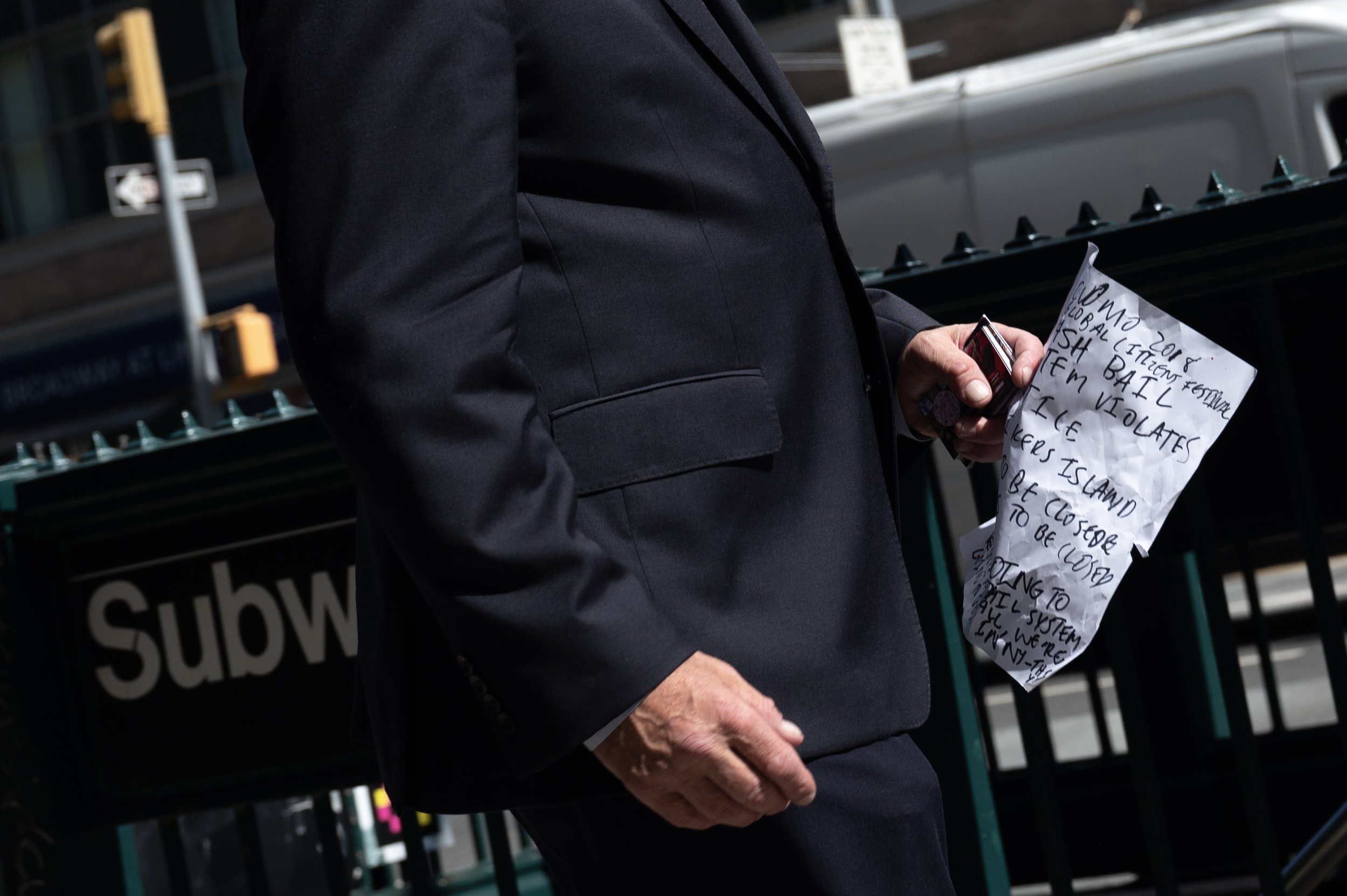 New York City Republican mayoral candidate Curtis Sliwa carries notes to speak to the media at a campaign event outside a Manhattan subway station on Sept. 26, 2025 in New York City.  