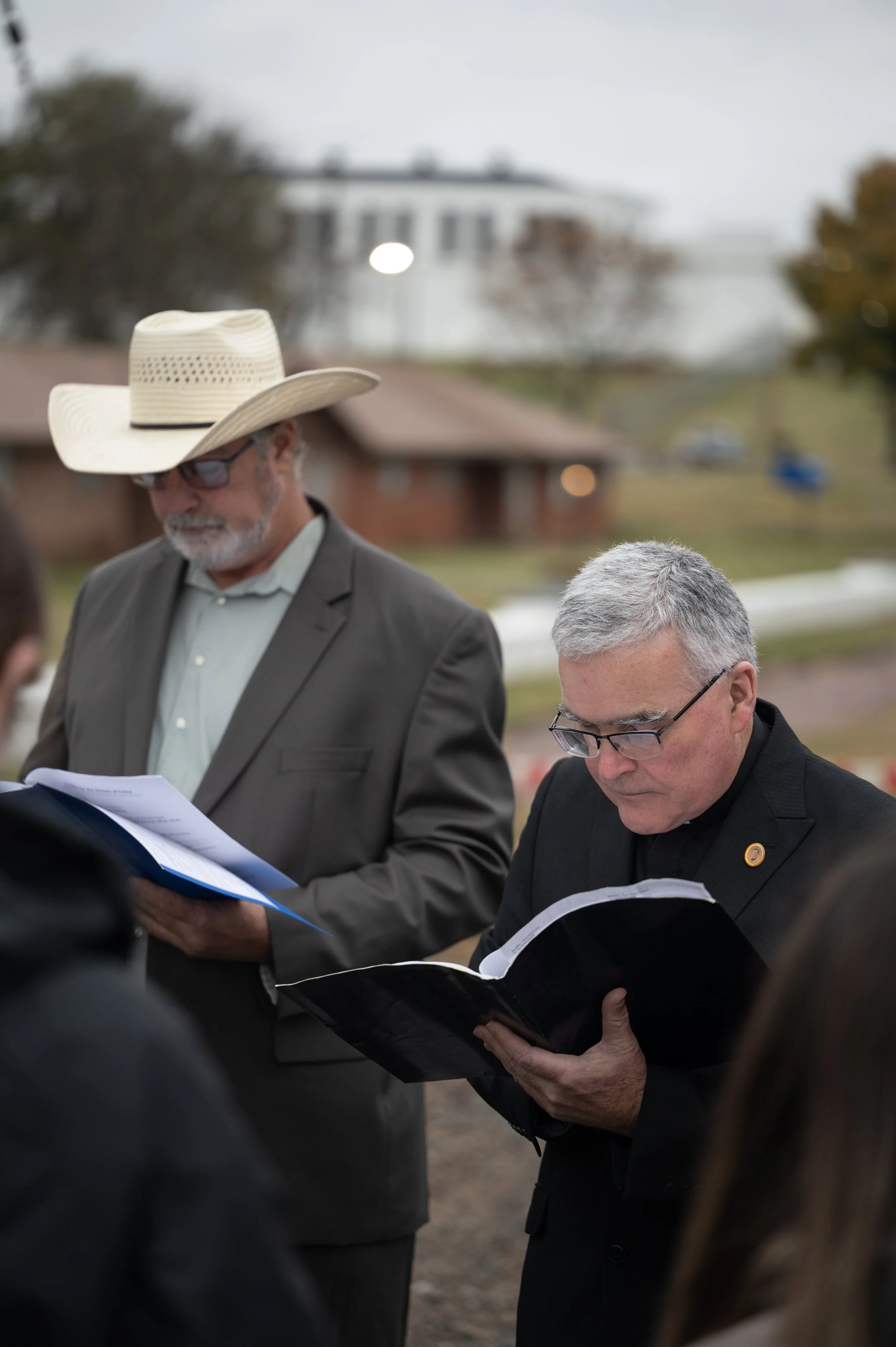Alan Knight, left, and Father Bryan Brooks pray during a vigil outside McAlester Prison while Phillip Hancock is executed inside on Nov. 30, 2023. Knight was friends with Hancock for 44 years, since they were young teenagers. Brooks has organized vig