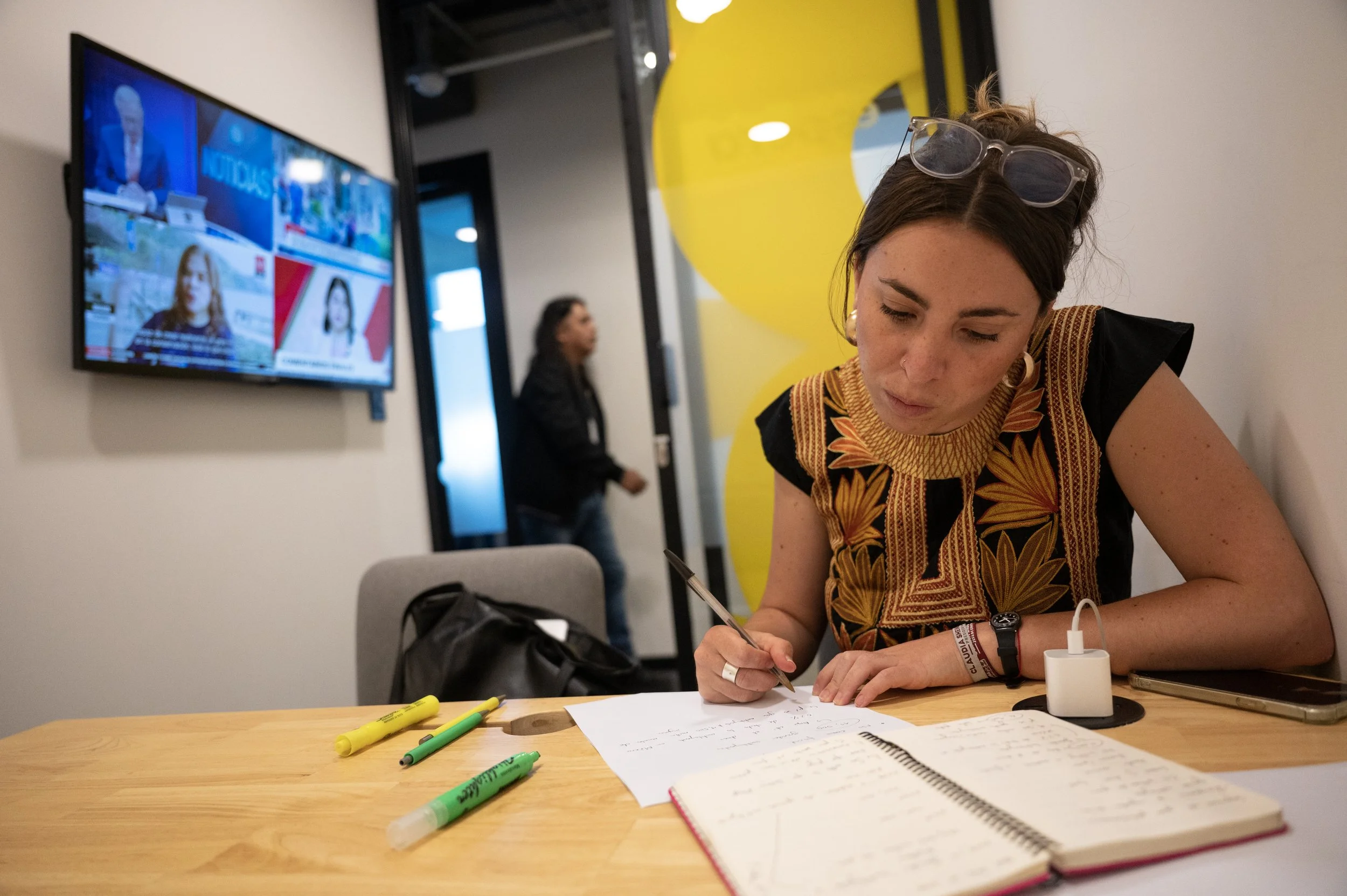 ulia Alvarez Icaza Ramirez, a spokesperson for Claudia Sheinbaum’s presidential campaign, prepares her notes before participating in a weekly radio interview program with other campaign representatives on April 17, 2024, in Mexico City. Mexico is exp
