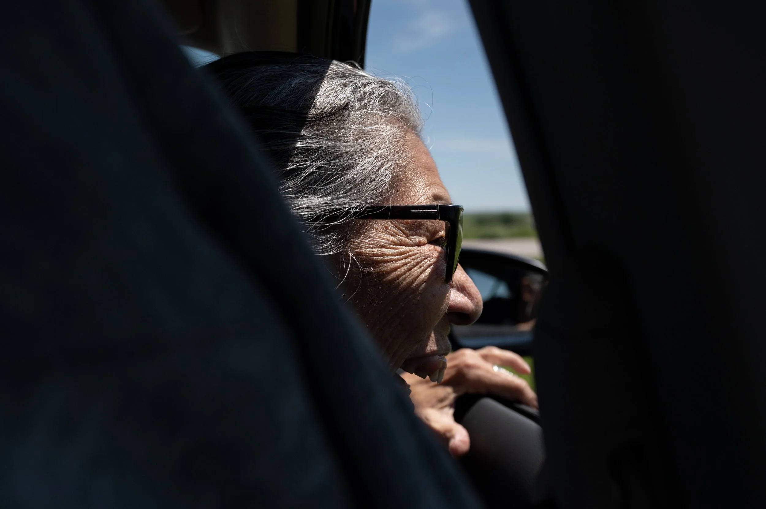 Madonna Thunder Hawk waves to her granddaughter at the Thunder Ridge housing development May 30, 2023, on Pine Ridge Reservation in South Dakota. 