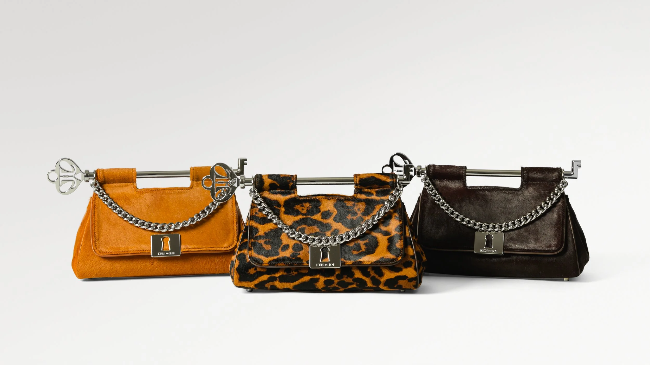Three handbags with chains and lock symbols on a white background.
