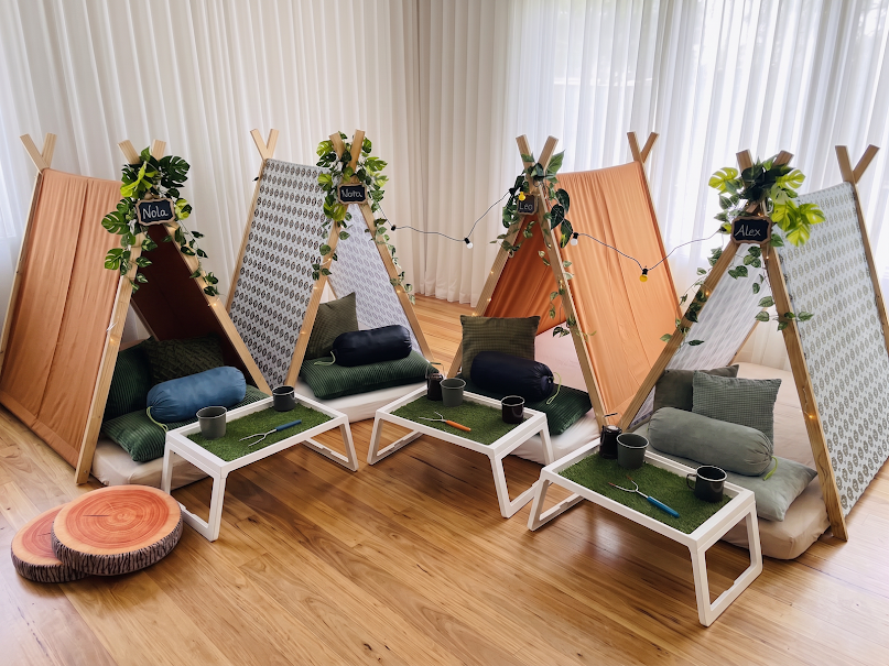 Indoor camping themed teepee party with cosy bedding and camping decor.