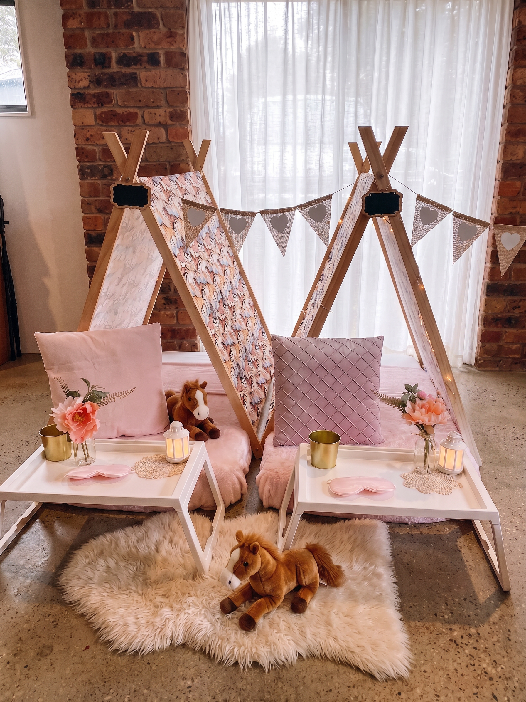 Two kids teepees with beautiful horse fabric, bunting and styling. Horse themes kids slumber sleepover party setup. 