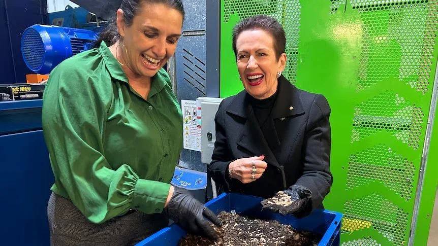 Olympia Yarger (left) introduces Lord Mayor Clover Moore to the maggots that will soon be handling Sydney's food scraps.