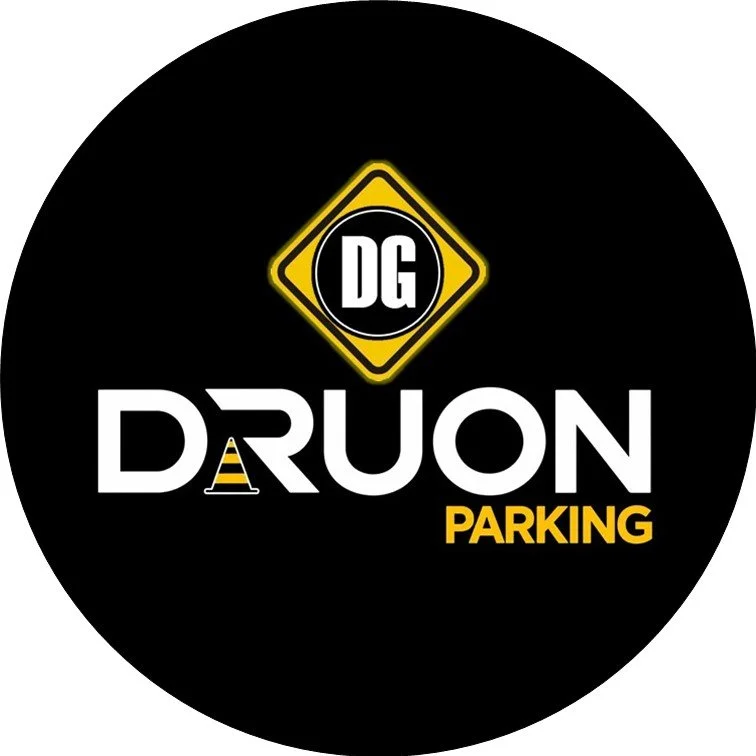 Logo circular de color negro con letras blancas que dice 'DRUON PARKING' y un símbolo amarillo de advertencia con las letras 'DG' en el centro.