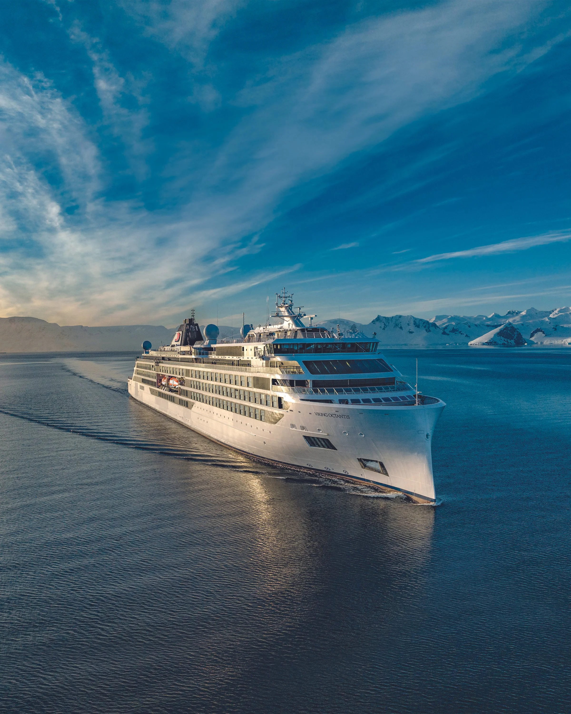 The Viking Octantis expedition ship sailing through icy polar waters, highlighting premium polar cruises and expertly coordinated nautical expeditions.