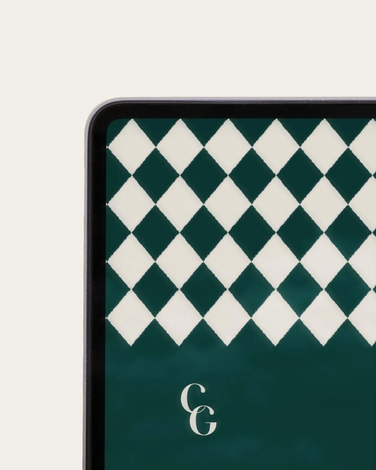 Close-up of a smartphone screen displaying a green and white diamond pattern background, with the letters 'C G' from Café Garçon at the bottom.