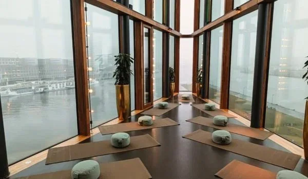 Yoga mats on Malabar at hotel Jakarta - a glass-walled room overlooking the water - prepared for a class.