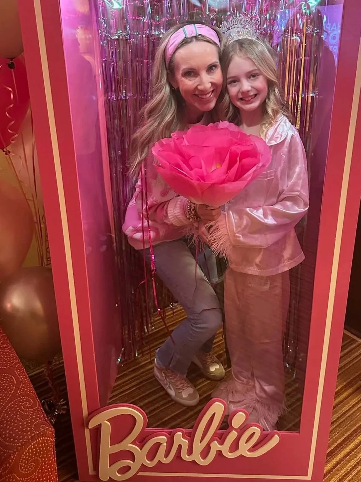 Pink Barbie-themed empty standing mirror frame with the Barbie logo at the bottom, placed against a green background.