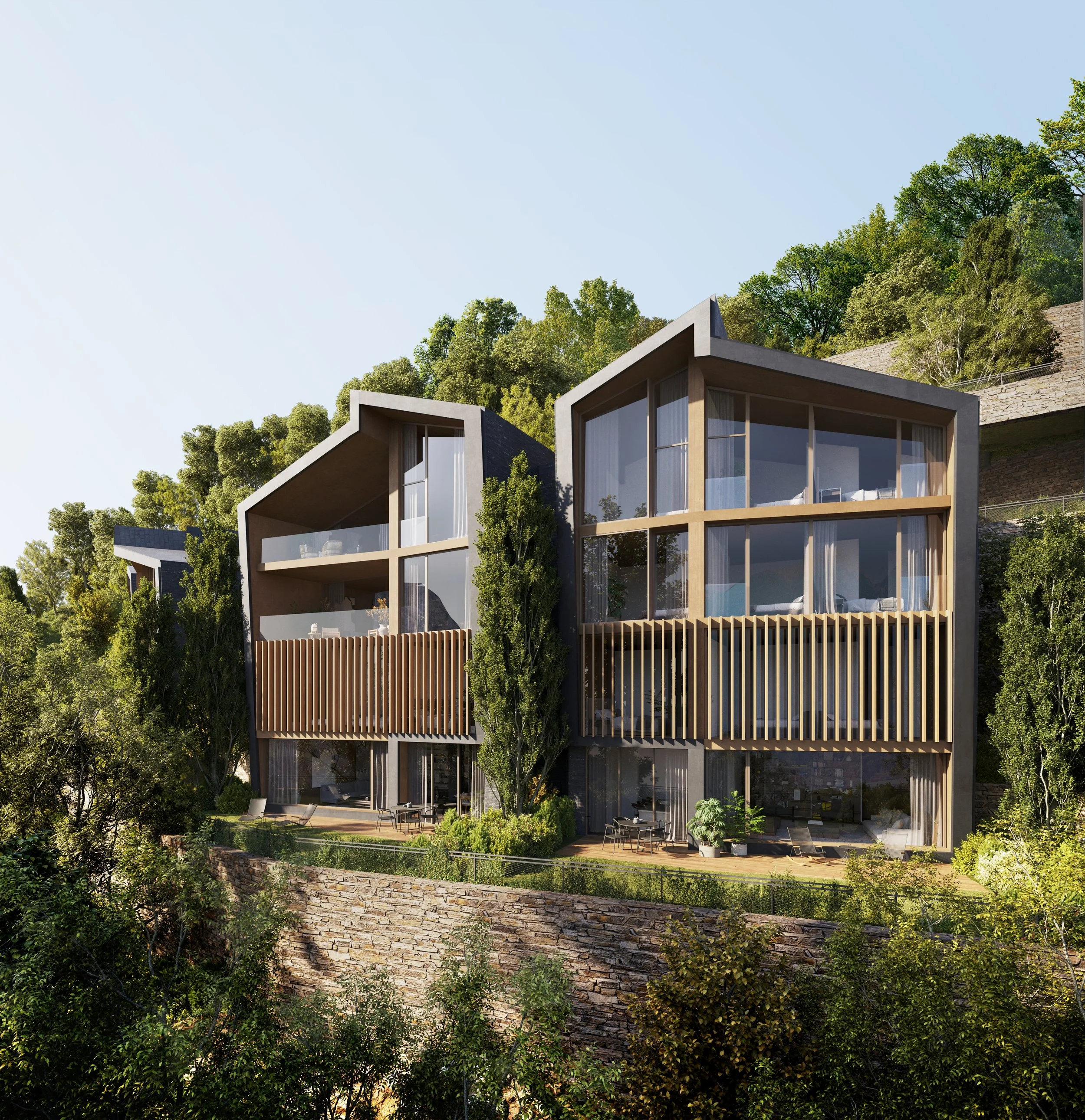 Casas modernas de madera y vidrio en una colina rodeadas de árboles y vegetación.