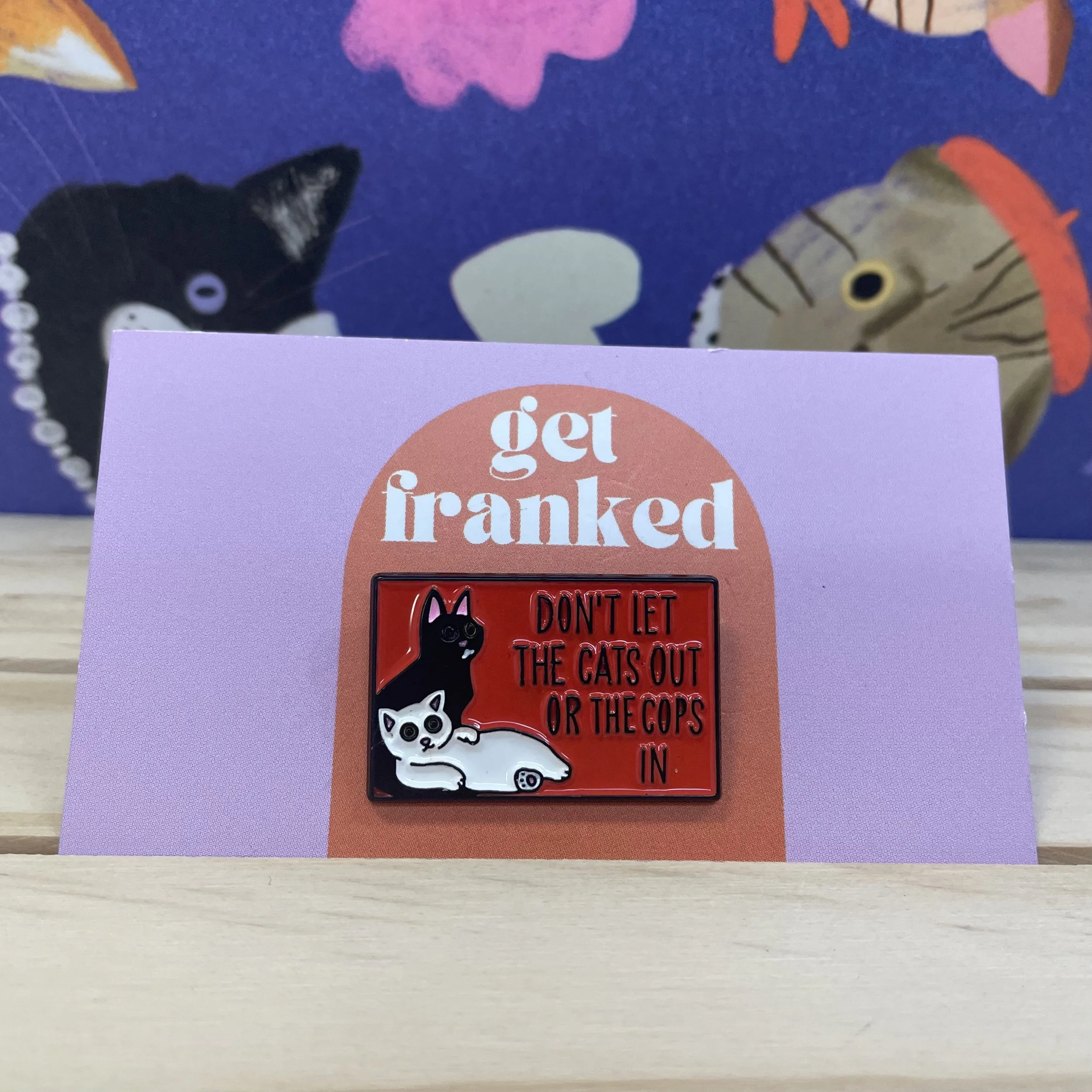 Pin: "Don't let the cats out or the cops in"