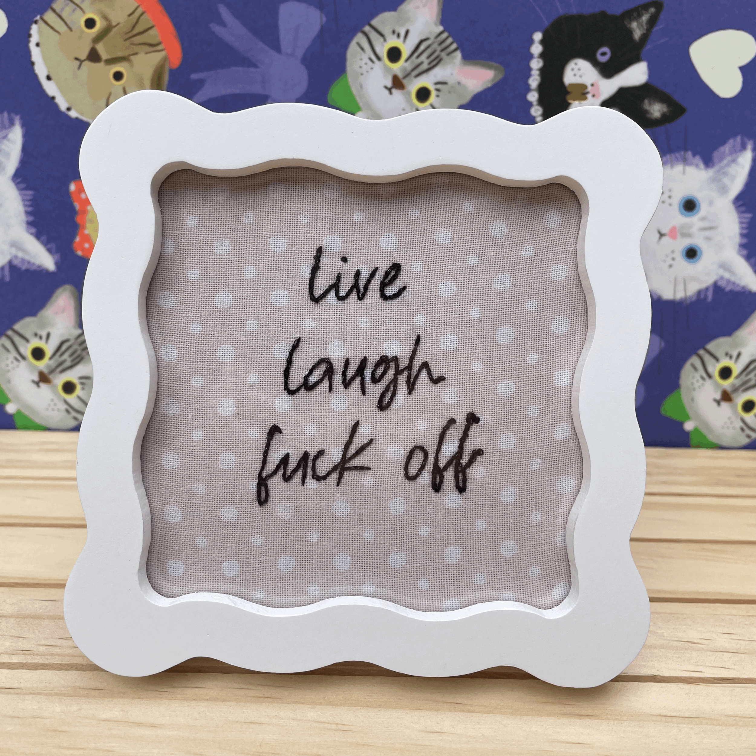 Frame: "Live laugh f*** off"
