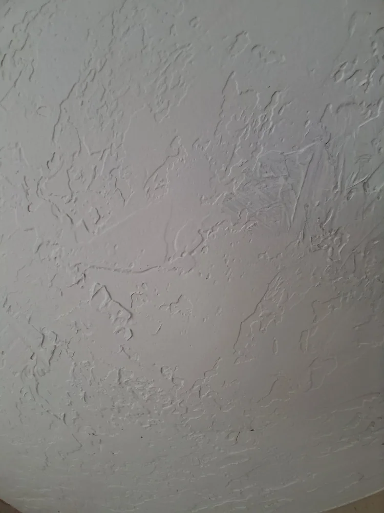 After repair: the drywall has been patched and the wall texture restored.