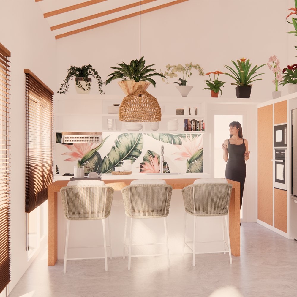 Bright kitchen with tropical floral wallpaper, ceiling beams, and wooden blinds. A woman in a black dress stands near a door, with a large kitchen island and three chairs in the foreground. Various potted plants and decorative items are on the upper