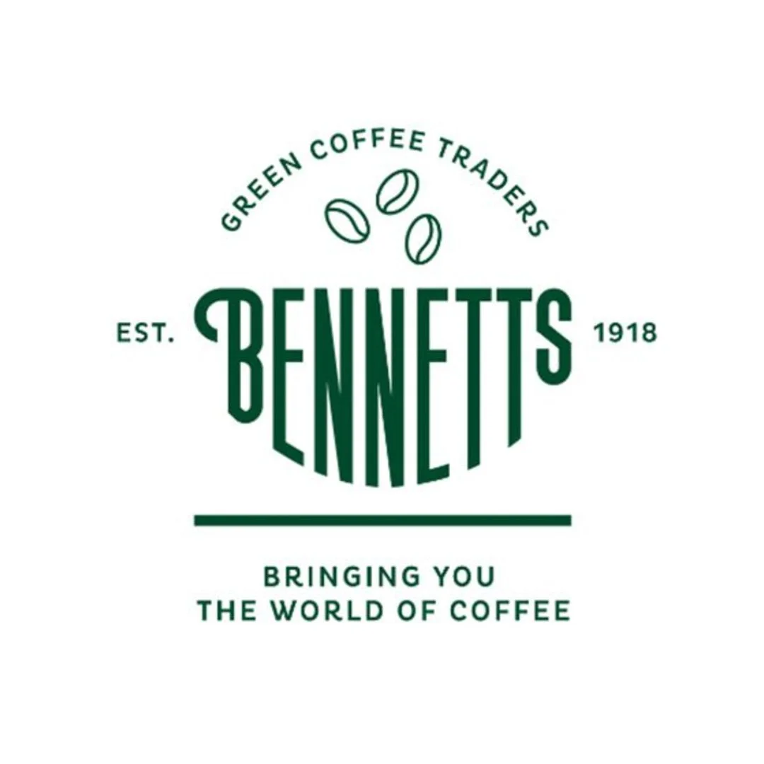 Logo for Bennetts Green Coffee Traders with coffee beans and text 'EST. 1918' and 'Bringing you the world of coffee' in green on a white background.