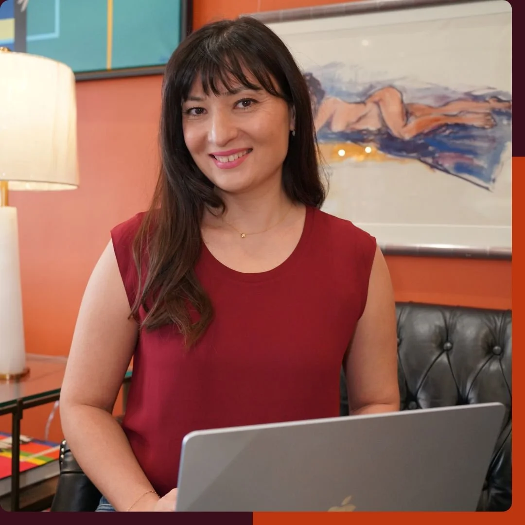 Katerina DeCouto, web designer for service providers, working on a laptop