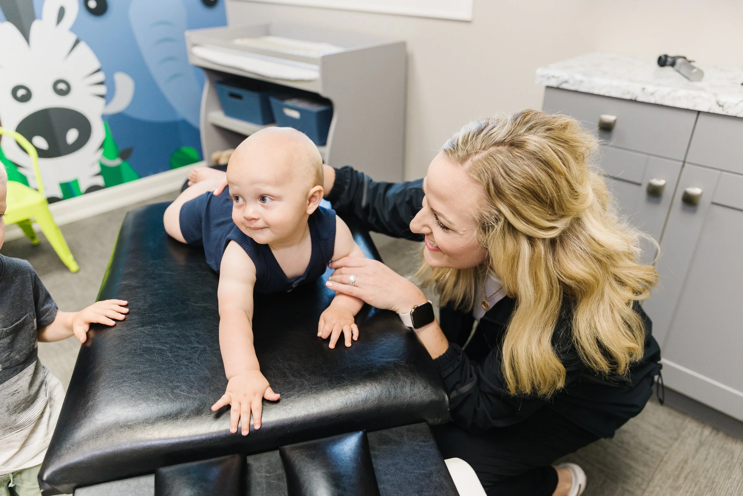 Dr. Ashley, prenatal and pediatric chiropractor, adjusting a baby in her clinic