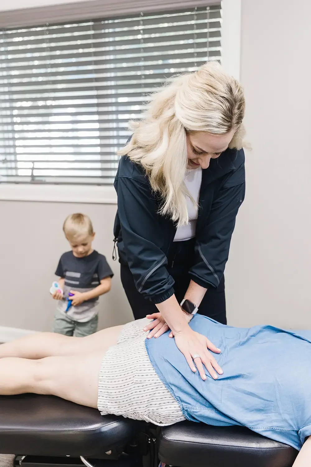 Chiropractor adjusting postpartum mom in Sioux Falls