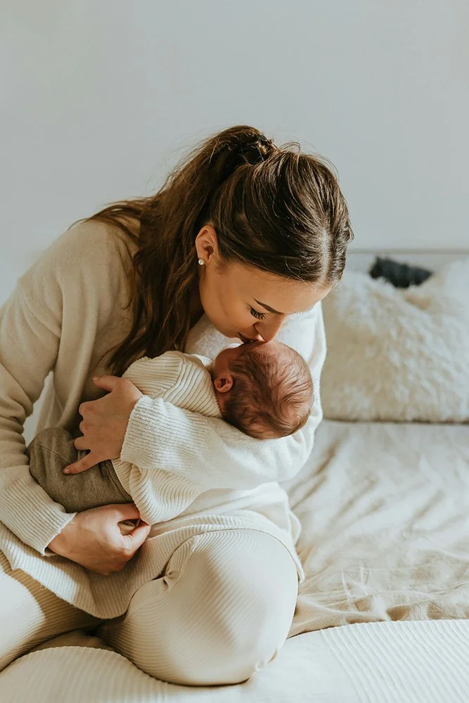 New mom in postpartum period holding baby after healing with chiropractic care in Sioux Falls, SD
