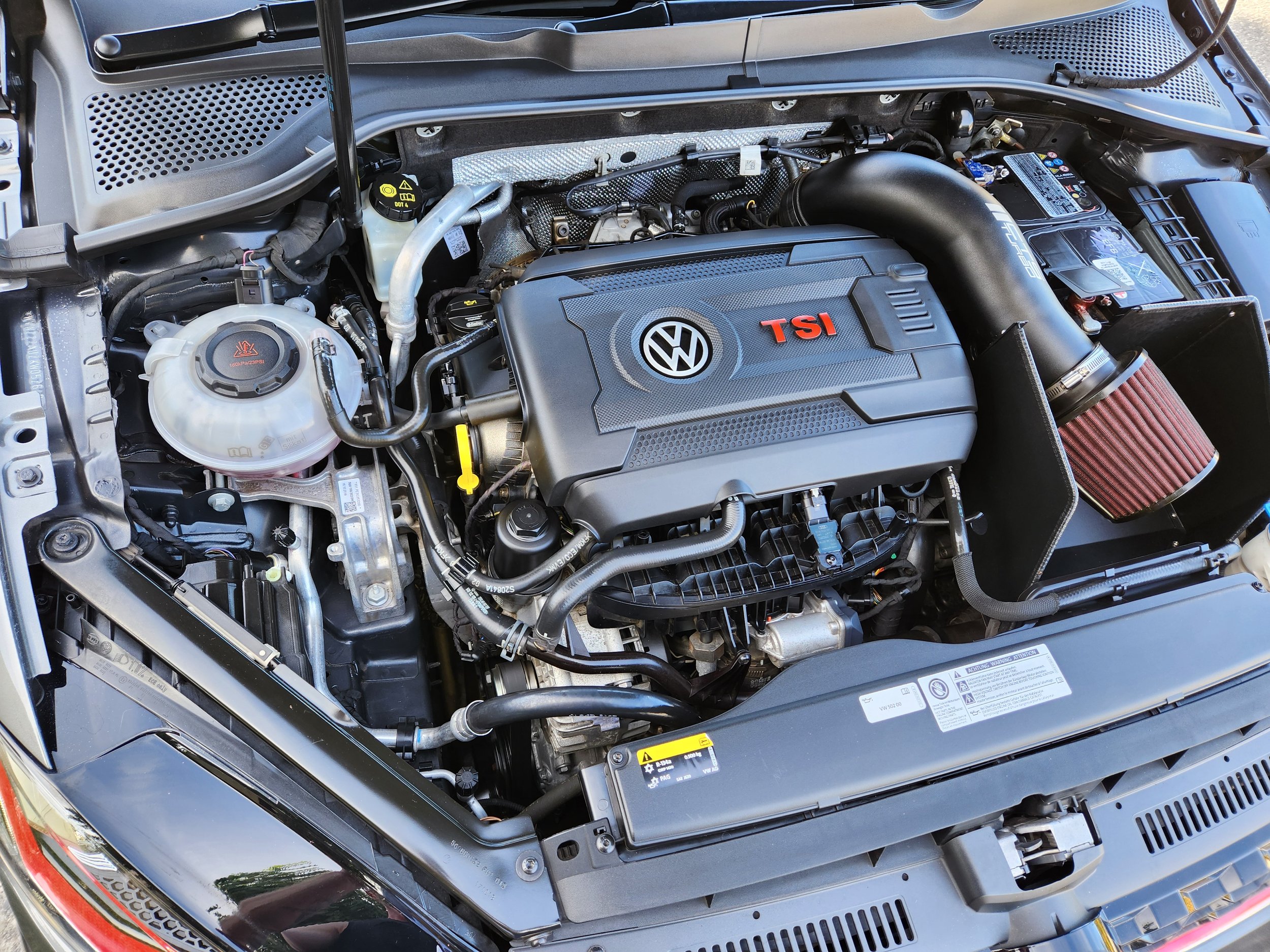 Under the hood of a Volkswagen car with a TSI engine, that has just been detailed.