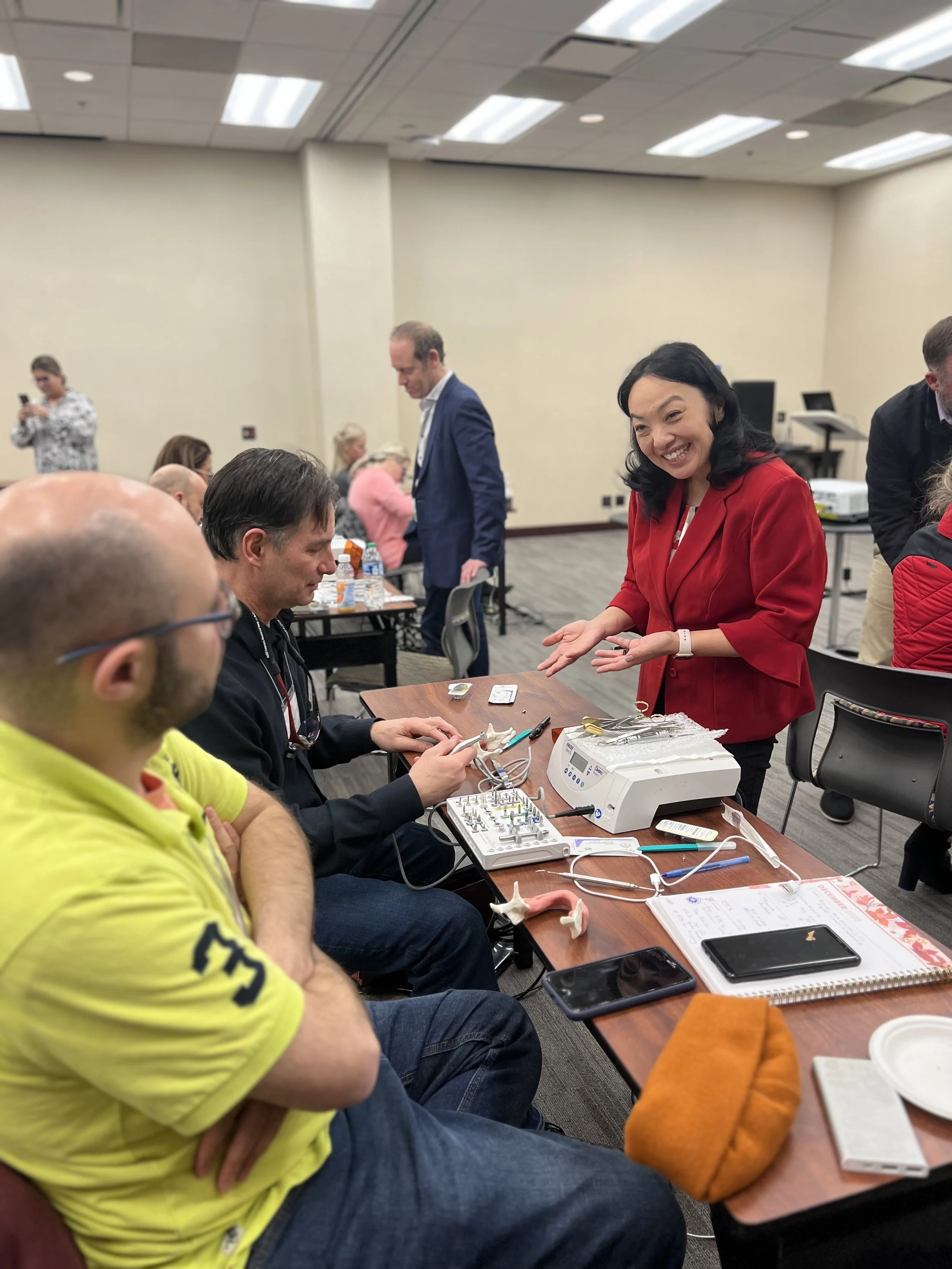 Team of dentists learning about implant dentistry training from Dr. Natalie Wong